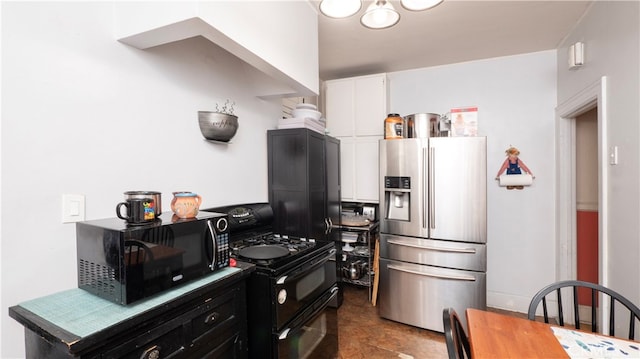 kitchen with black appliances and white cabinets