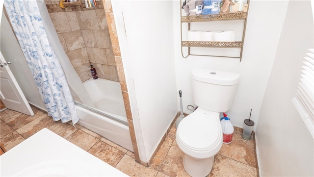 bathroom featuring shower / tub combo and toilet