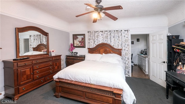 carpeted bedroom featuring ceiling fan and a textured ceiling