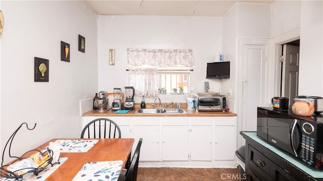 kitchen featuring sink and white cabinets