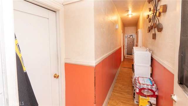 hallway with hardwood / wood-style flooring