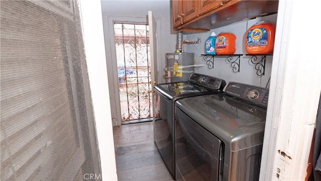 washroom with independent washer and dryer, wood-type flooring, water heater, and cabinets