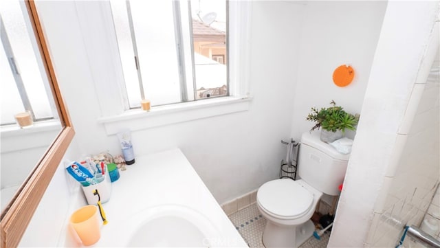 bathroom featuring tile patterned floors, vanity, and toilet