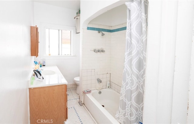 full bathroom with tile patterned floors, shower / bath combo, vanity, and toilet