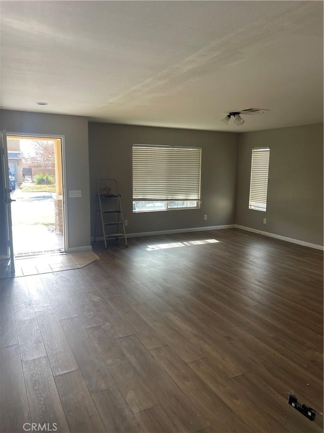 unfurnished room featuring dark wood-type flooring