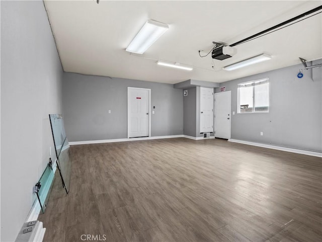 garage with baseboards and a garage door opener