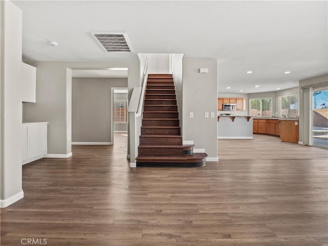 interior space featuring recessed lighting, visible vents, baseboards, and wood finished floors