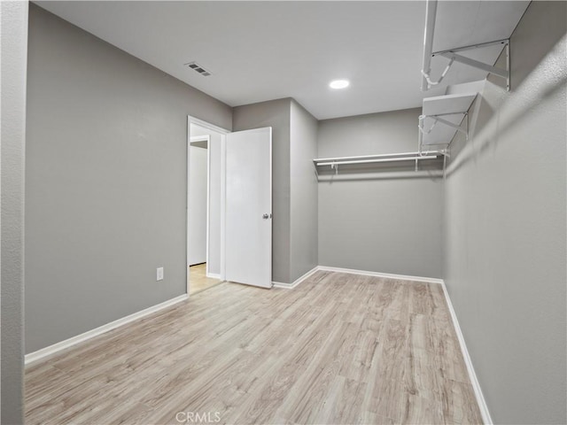 spacious closet featuring light wood-style flooring and visible vents