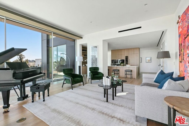 living room with plenty of natural light and light hardwood / wood-style floors