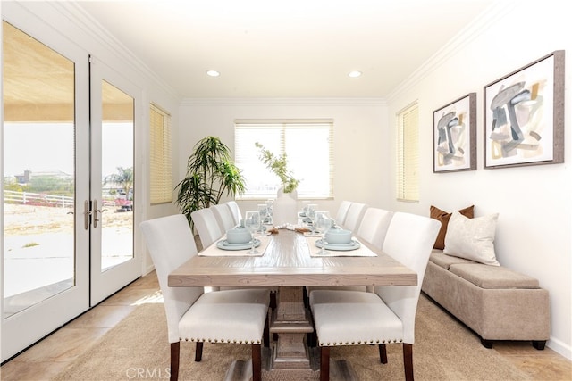 tiled dining area featuring french doors and crown molding