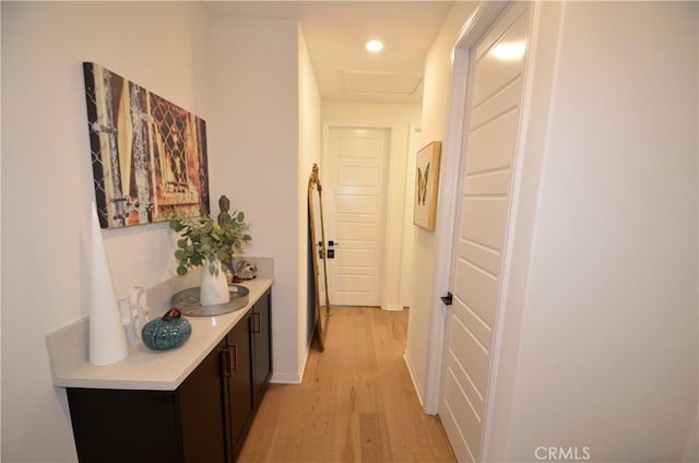 hallway with light hardwood / wood-style floors