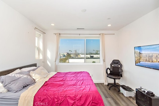 bedroom with hardwood / wood-style flooring