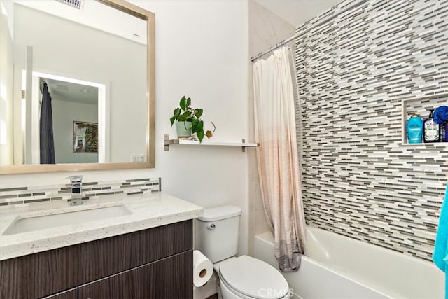 full bathroom with decorative backsplash, shower / bath combo, vanity, and toilet