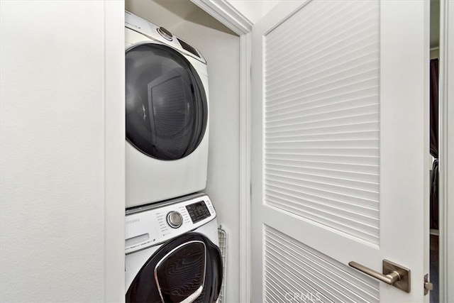 washroom featuring stacked washing maching and dryer