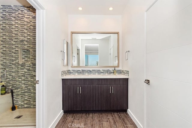 bathroom with an enclosed shower, backsplash, hardwood / wood-style floors, and vanity