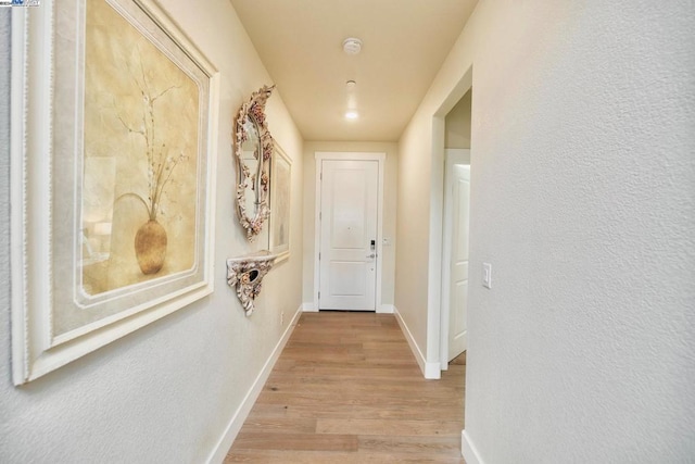 hall with light hardwood / wood-style flooring