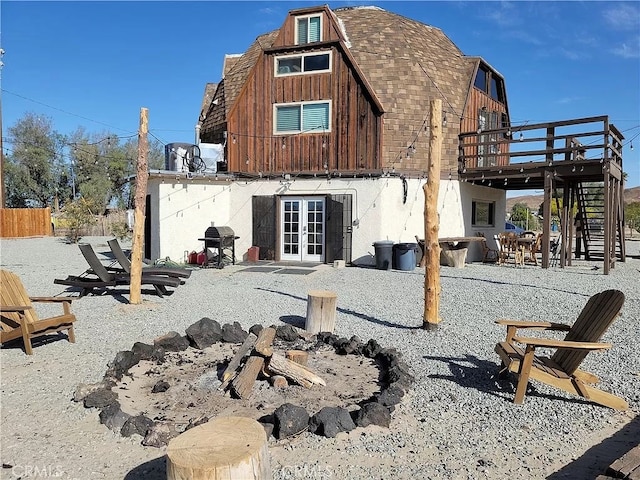 back of house featuring french doors, a patio, and a deck