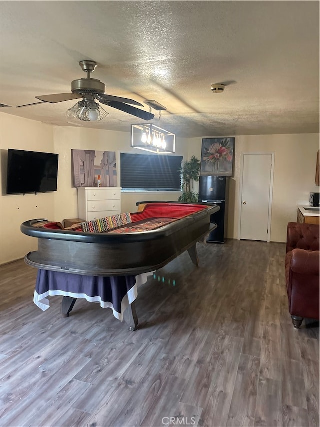 game room featuring a textured ceiling, wood-type flooring, and ceiling fan