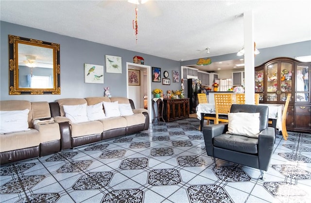 living room featuring tile patterned flooring and a textured ceiling