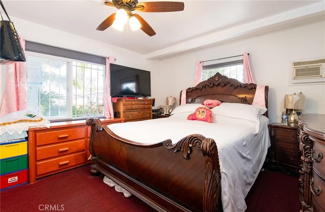 carpeted bedroom featuring a wall unit AC, multiple windows, and ceiling fan