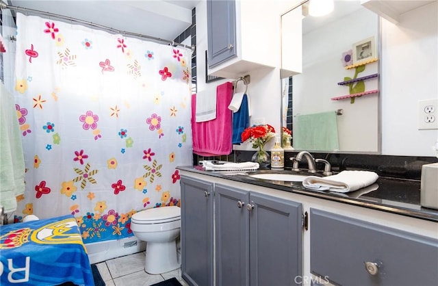 bathroom with tile patterned flooring, vanity, curtained shower, and toilet