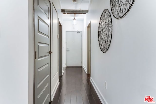 corridor featuring dark hardwood / wood-style floors