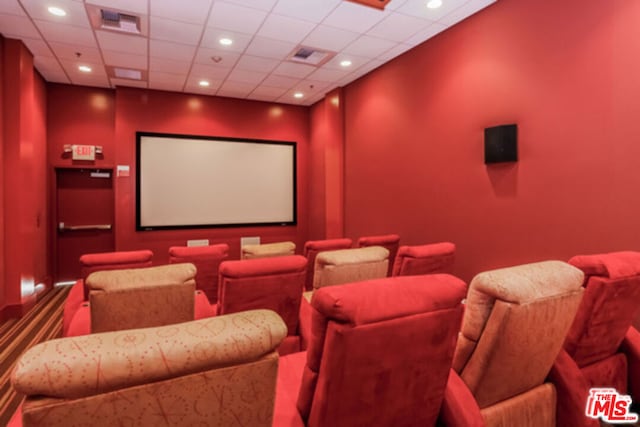 home theater room with a drop ceiling and carpet