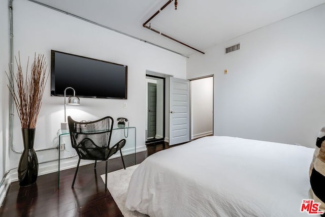 bedroom featuring dark hardwood / wood-style flooring