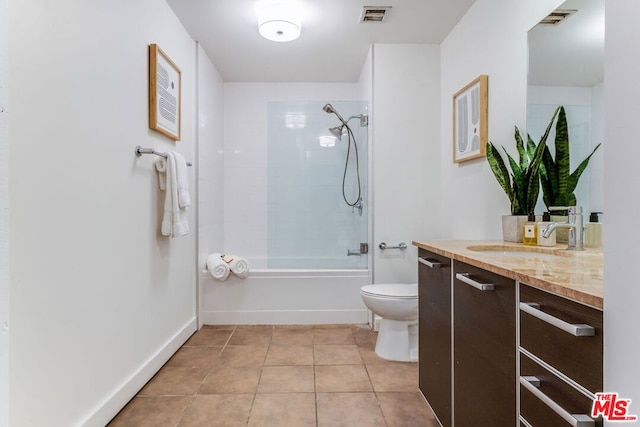 full bathroom with toilet, tile patterned flooring, vanity, and tiled shower / bath