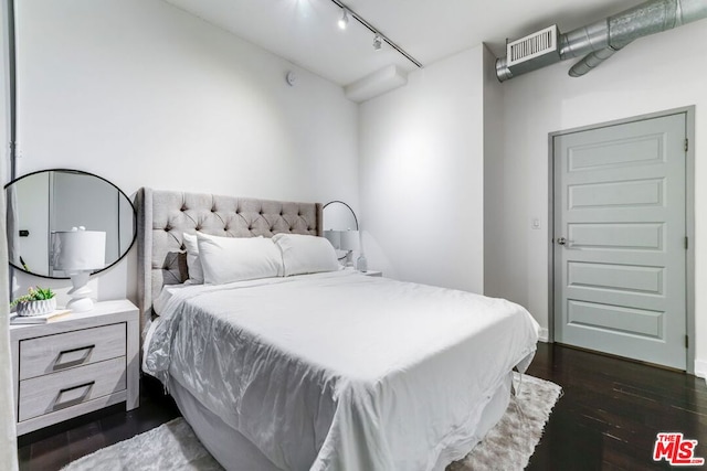 bedroom with dark wood-type flooring