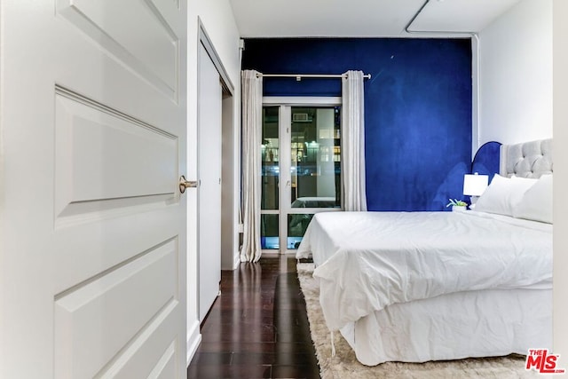 bedroom with a closet and dark wood-type flooring