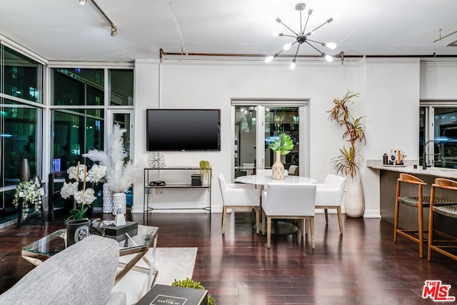 dining area featuring an inviting chandelier and dark hardwood / wood-style flooring