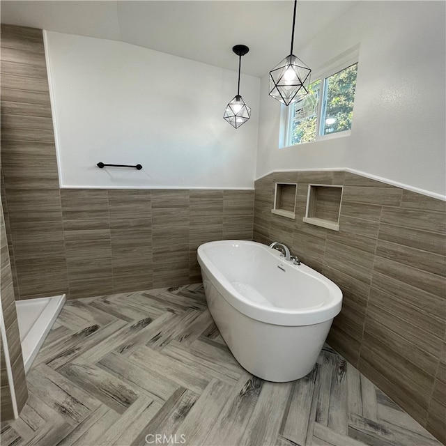 bathroom featuring tile walls and a bath