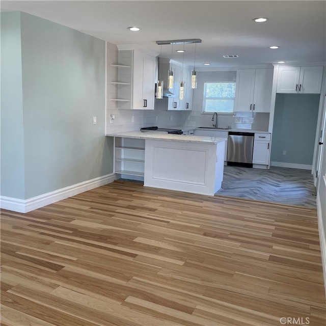 kitchen featuring dishwasher, white cabinetry, kitchen peninsula, and light hardwood / wood-style floors