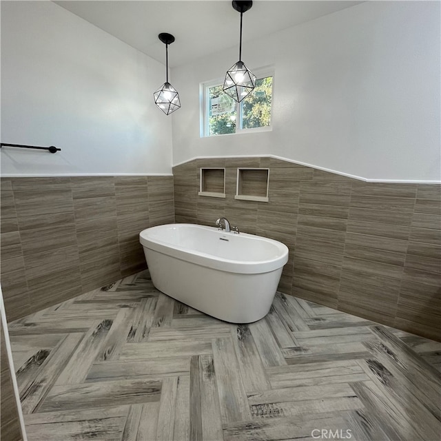 bathroom with tile walls and a washtub