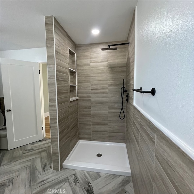 bathroom featuring tile walls and tiled shower