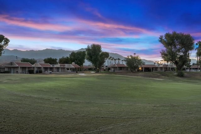 view of community featuring a mountain view and a lawn