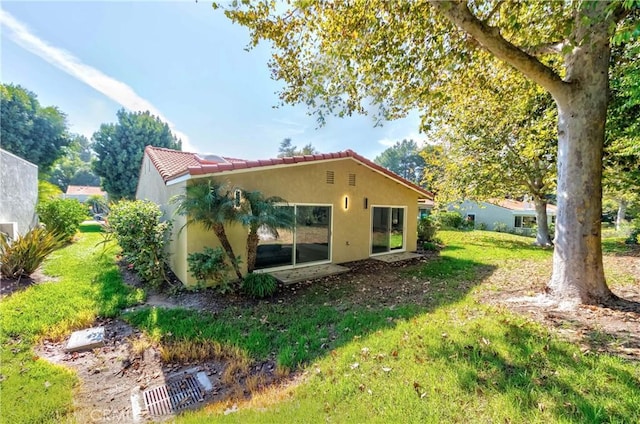 view of side of home featuring a yard