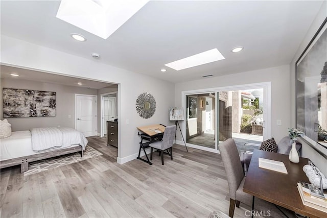 office featuring a skylight and light hardwood / wood-style floors