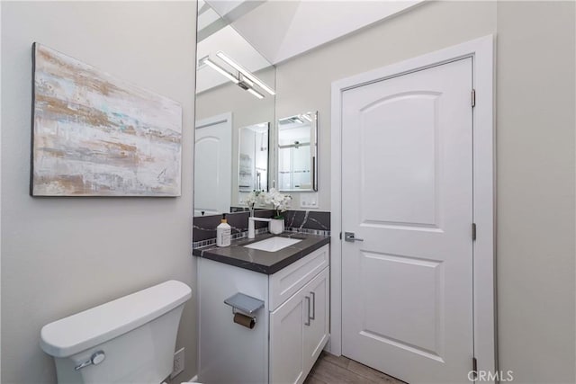 bathroom featuring hardwood / wood-style floors, vanity, and toilet