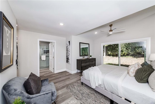 bedroom with access to exterior, ensuite bathroom, vaulted ceiling, ceiling fan, and hardwood / wood-style flooring