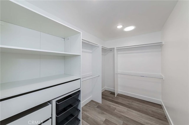 spacious closet featuring hardwood / wood-style floors