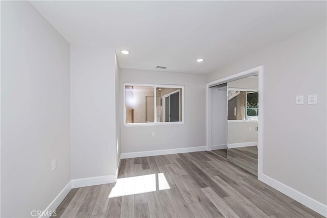 unfurnished room with light hardwood / wood-style flooring