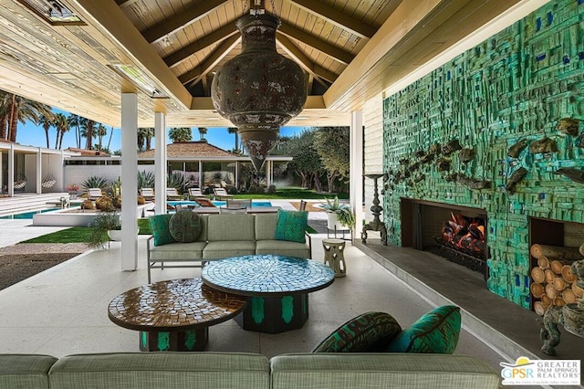 view of patio / terrace featuring an outdoor living space with a fireplace and a gazebo