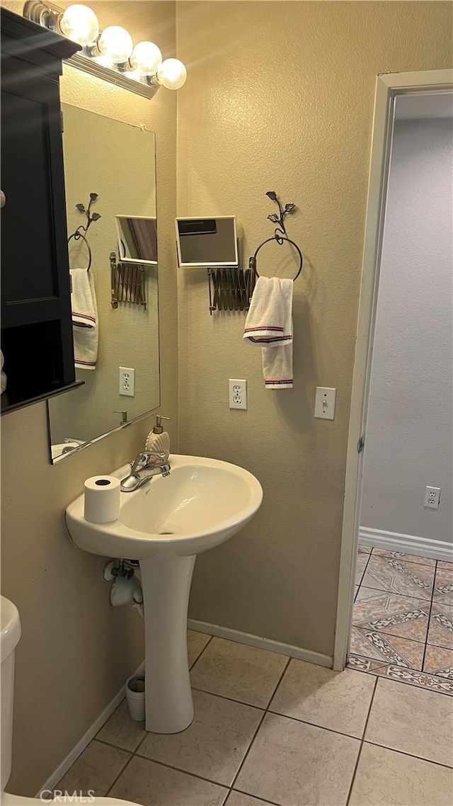 bathroom featuring toilet and tile patterned floors