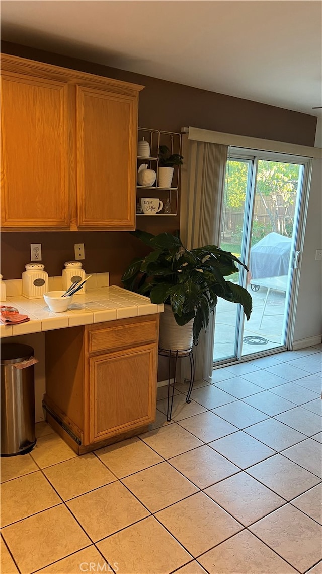 kitchen with tile countertops and light tile patterned floors