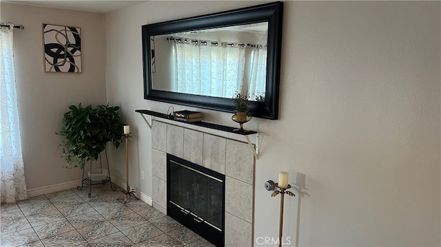 living room featuring a tiled fireplace