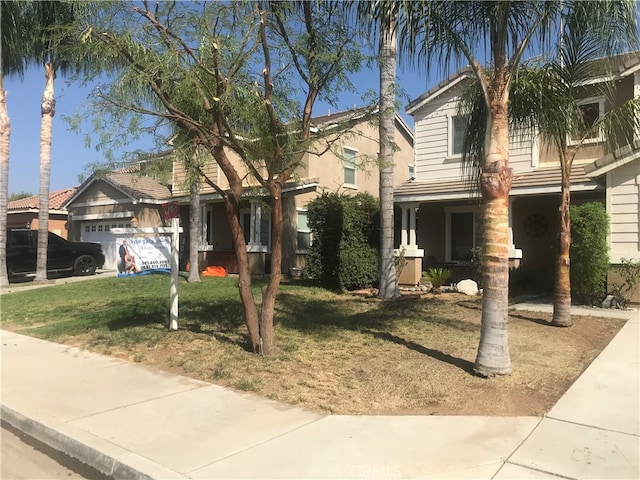 view of front of home with a front yard and a garage