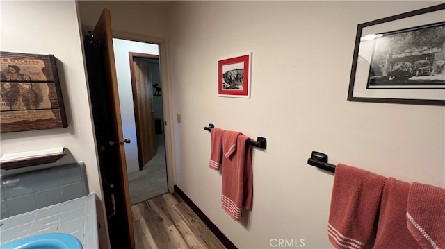 bathroom featuring hardwood / wood-style floors and tasteful backsplash