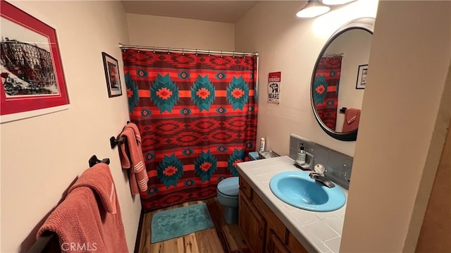 bathroom with walk in shower, vanity, hardwood / wood-style floors, and toilet